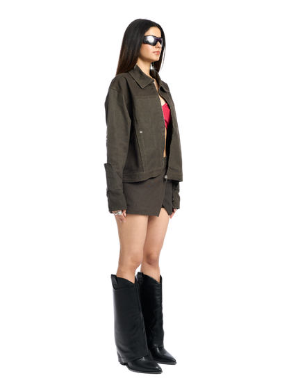 Woman wearing a green jacket and black boots on a white background